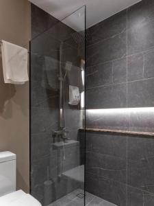 a shower with a glass door in a bathroom at Lakwa Motel Lio Beach in El Nido +32 photos