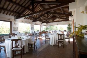 a dining room with white tables and chairs at La Tenuta Dei Ciclamini in Avigliano