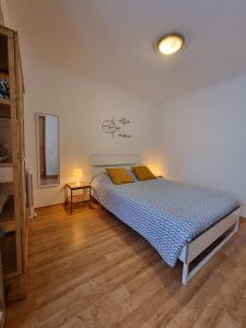 a bedroom with a bed with blue and yellow pillows at Casa da Anunciada | Old Town in Setúbal
