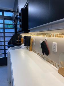 a kitchen with a white counter and a sink at Garden Moinhos de Vento in Porto Alegre +21 photos