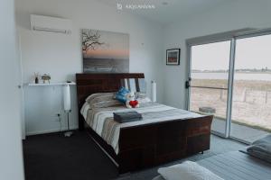 a bedroom with a bed with a teddy bear on it at Coorong Island Retreat - Farm Stay at Pet Friendly Property in Meningie