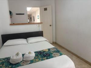 Letto o letti in una camera di Hotel Portal Guatapé