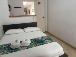 Letto o letti in una camera di Hotel Portal Guatapé
