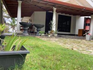 a patio with two large fountains in a yard at Serenity cove Dondra in Dondra West