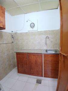 a small bathroom with a sink and a shower at Al Ain Mall Transient Studio in Al Ain