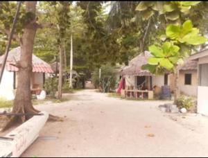 a dirt road with a house and a tree at Phangan Cosy Bungalow - ban tai in Baan Tai +4 photos