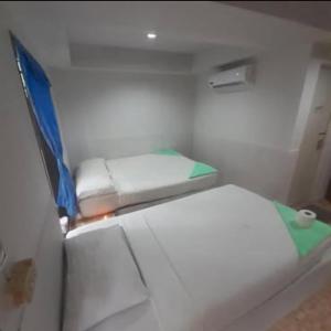 a small room with two beds on a boat at Phangan Cosy Bungalow - ban tai in Baan Tai