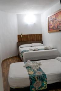 Postel nebo postele na pokoji v ubytování Hotel Portal Guatapé