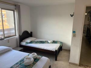 Letto o letti in una camera di Hotel Portal Guatapé