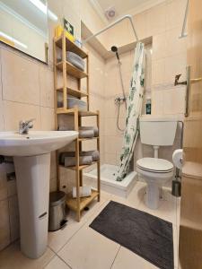 a bathroom with a sink and a toilet and a shower at Casa da Anunciada | Old Town in Setúbal +35 photos