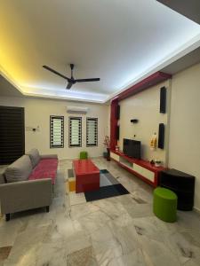 a living room with a couch and a ceiling fan at AirPutih7 4R3BHomestay 5 min to Town&Mall 8-13pax in Kuantan