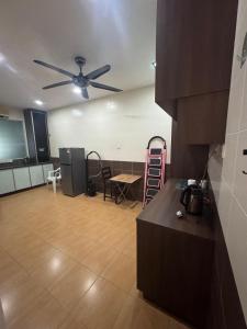 a living room with a ceiling fan and a table at AirPutih7 4R3BHomestay 5 min to Town&Mall 8-13pax in Kuantan