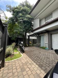 a motorcycle parked in front of a house at Cipedes Mansion in Bandung +10 photos