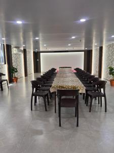 a large conference room with a long table and chairs at Hotel soumya sarovar in Jagdalpur