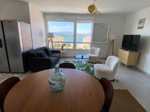 a living room with a table and a living room with a view at Port Leucate T4 Duplex Climatisé, 6 Pers, Vue Chenal, Wifi, Parking - FR-1-798-56 in Leucate