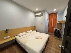 a bedroom with a bed with two pillows on it at Tropical villa in Kuantan +36 photos