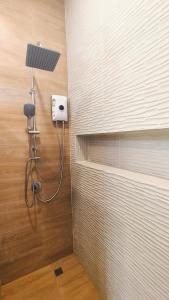 a bathroom with a shower with a light on the wall at 2-Bedroom Maduea Wan House in Ko Phangan +23 photos