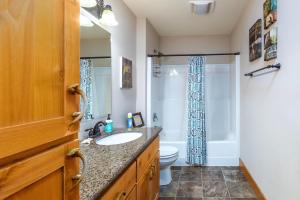 a bathroom with a sink and a toilet and a shower at `Antler Ridge` Hot tub, Wifi, BBQ, River Access! in Packwood +61 photos