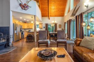 a living room with a couch and a table at `Antler Ridge` Hot tub, Wifi, BBQ, River Access! in Packwood