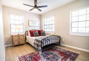 a bedroom with a bed and a ceiling fan at Family Fun Retreat - Heated Pool & Arcades in Jacksonville +26 photos