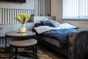 a bedroom with a bed and a table with a plant on it at Eithad, Coop Live, Old Trafford with Free Parking in Manchester