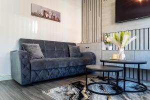 a living room with a couch and a table at Eithad, Coop Live, Old Trafford with Free Parking in Manchester