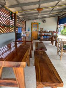 a group of wooden tables in a room at Liam Resort in Prachuap Khiri Khan