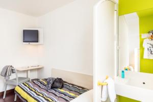 a small bedroom with a bed and a desk at Unisotel GAP -" Ex HôtelF1" in Gap +11 photos