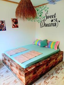 a bed in a room with a sign that reads sweet dreams at Mint hause in Nungwi