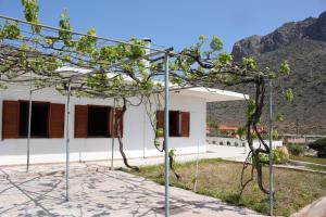 a view of a house with a tree at Theros Beach House in Stavros
