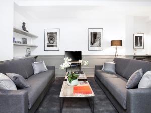 a living room with two couches and a coffee table at LivinParis - Luxury 3 Bedrooms Le Marais I in Paris