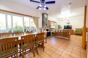 a dining room with a table and benches at 4 Bedroom Log Cabin in Camp John Hay Baguio in Baguio