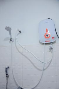 a white shower with aitizer at Ellagama Village Bungalow in Diyatalawa