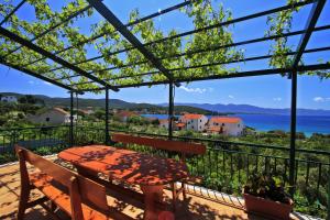 a balcony with a table and a view of the water at Apartments Đuričić in Lovište