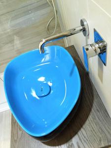 a blue sink with a faucet in a bathroom at Profumo d'aMARE in Polignano a Mare