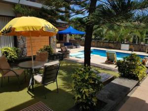 a table with an umbrella next to a pool at Villa 1 in Fond du Sac