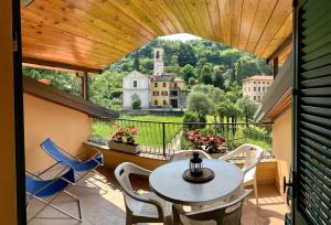 a balcony with a table and chairs and a view at The Lady of the Lake - Penthouse with Large Terrace and Lake View in Griante Cadenabbia