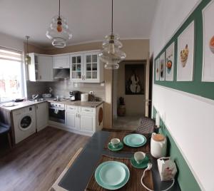 a kitchen with a table with green plates on it at Varna Moreto in Varna City