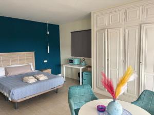 a bedroom with a bed and a table and chairs at Amaca in Mijas Costa
