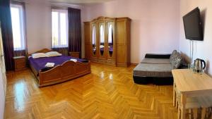 a bedroom with a bed and a wooden floor at Mini-Hotel Sakvoyage in Chernivtsi