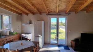 a kitchen with a refrigerator and a large window at Teta's Holiday Home in Melíkia