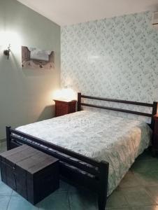 a bedroom with a bed with a bench next to it at Casale del sole in Palestrina