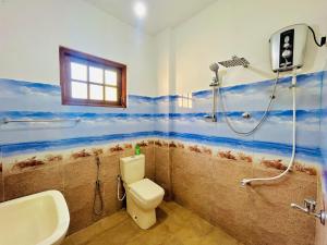 a bathroom with a shower and a toilet and a sink at Serene Stay - Cozy Upstairs Apartment in Waskaduwa