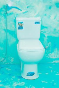 a white toilet in a bathroom with a shower at Zephyr Heights in Ahangama +25 photos