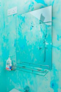 a mirror on the wall of a bathroom at Zephyr Heights in Ahangama
