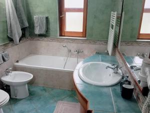 a bathroom with a tub and a sink and a toilet at Casale del sole in Palestrina +19 photos