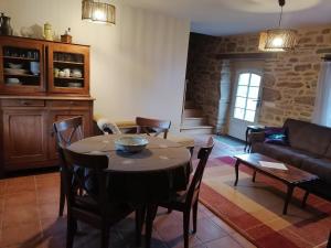 a living room with a table and a couch at Frairie Du Divit in Pontivy