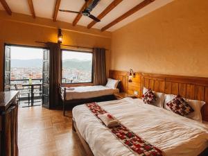 ein Schlafzimmer mit großem Bett und großem Fenster in der Unterkunft Hotel Tourist Residency in Pokhara