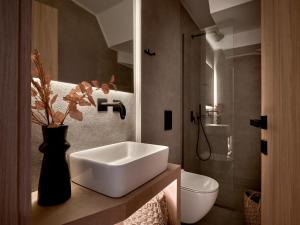 a bathroom with a white sink and a toilet at Pιgeon Nest Villa in Psarou +44 photos