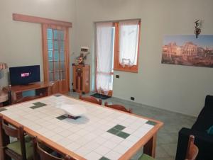 a dining room with a table and chairs and a room with at Casale del sole in Palestrina